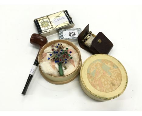 A 1940's ladies cigarette holder, powder dispenser and watch in case, two cigarette lighters incl. ' The Roller Beacon', pipe