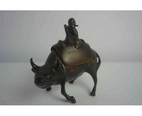 Chinese Bronze Censer, circa late 19th / early 20th century, Modelled as a Buddha playing flute on a water buffalo, 11cm high