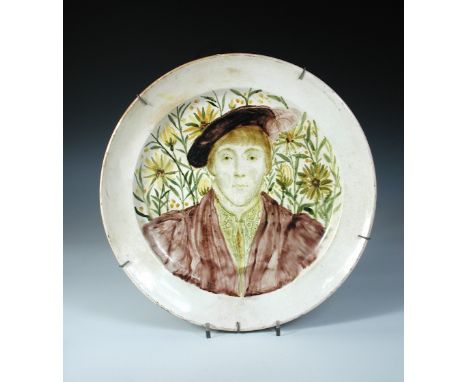 A Gateshead Art Pottery charger painted with a portrait of Edward VI after Hans Holbein, circa 1880-84, painted by Thomas Ral