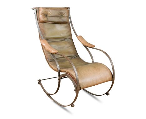 An early 20th century bent steel rocking chair in the manner of R. W. Winfield, with tan leather seat and arm rests 107cm (42