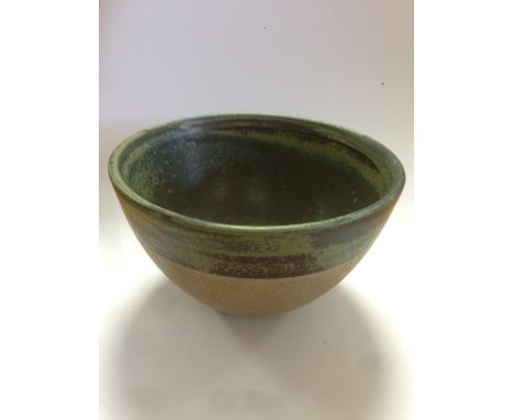 § Robin Welch (British, b.1936), a stoneware bowl, glazed both internally and to the upper section of the outer with a green/