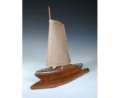 An Art Deco style table lamp modelled as a yacht, the oak base with aluminium fittings, the shade fitted as the sail 43 x 44c