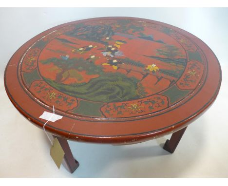 A late 19th/early 20th century Chinese red lacquered table, decorated with children playing, H.51 D.90cm 