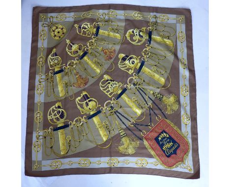 A vintage Hermes silk scarf in brown entitled 'Cliquetis', Designer: J. Abadie, 85 x 90cm approx 