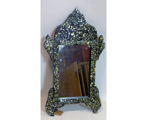 A Middle Eastern ebonised mirror with mother of pearl inlay, 75 x 44cm 