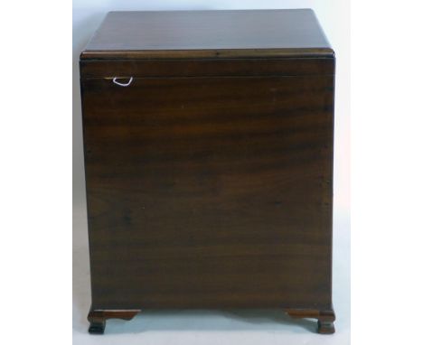 An early 20th century Chinese camphor wood trunk, with hinged lid enclosing pull out sectioned compartment, above side drawer