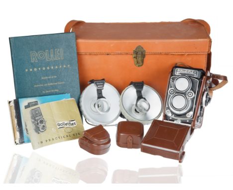 A VINTAGE ROLLEIFLEX 2,8 F WITH ORIGINAL LEATHER CASE AND ACCESSORIES  Rolleiflex in original leather carrying case accompani