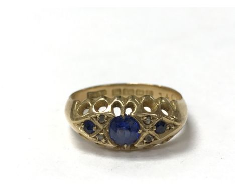 An 18ct gold ring set with three sapphires, the ring size is between k and l. Weighing approximately