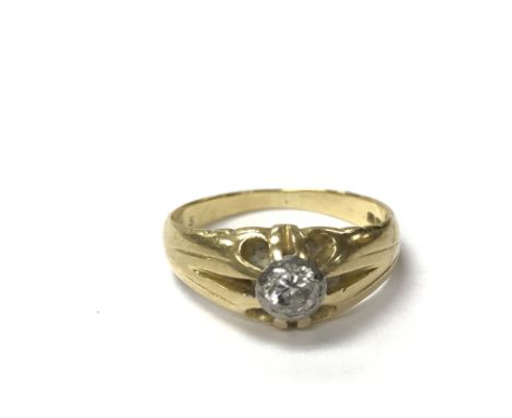 An 18ct gold ring set with a central diamond, the approximate ring size is R.