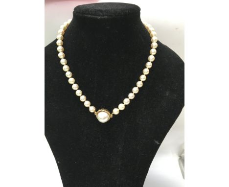 A Pearl necklace with 9 ct gold clasp .