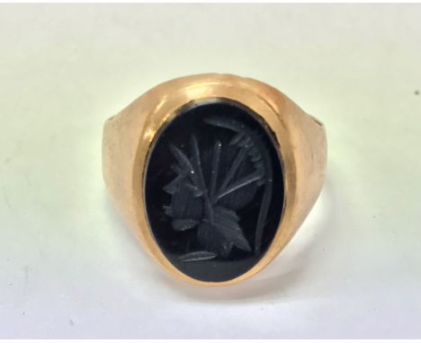 A 9ct gold signet ring measuring approximately R and weighing approximately 4.25g.