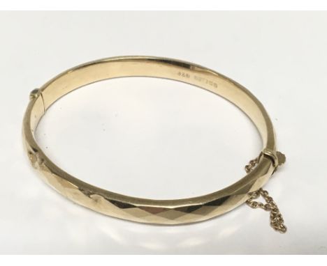 A 9carat gold bangle with a patterned edge weight 8.4g