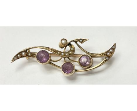 A 15ct gold Edwardian seed pearl and amethyst brooch.