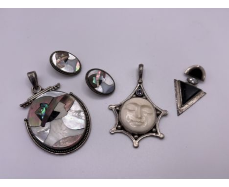 A silver and mother of Pearl Art Deco style pendant and earrings together with 2 additional silver pendants.