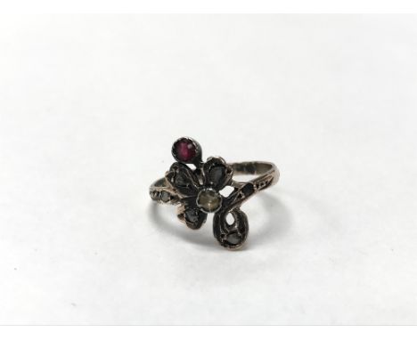 A vintage art nouveau 8ct gold ring set with rose cut diamonds and a ruby. The approximate ring size is N.