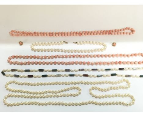 A collection of Pearl and Stove necklaces including a pair of earrings.