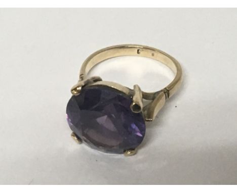 A 9carat gold ring set with a round cut amethyst. Weight 5g ring size K-L