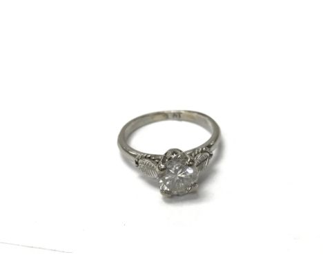 A platinum ring with a leaf design inset with a solitaire diamond. The approximate ring size is between k and L. Weighing app