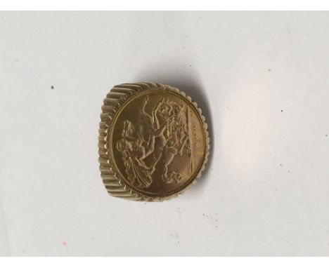 A gold ring inset with 1909 half sovereign 11 grams total.