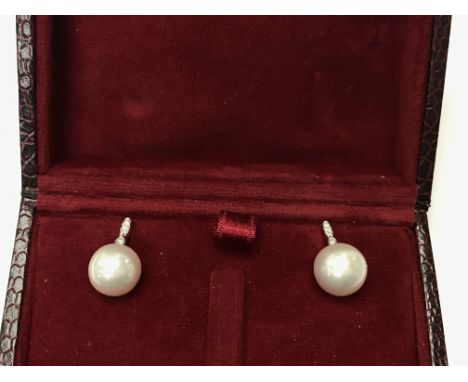 A pair of 9ct white gold cultured Pearl and diamond drop stud earrings, boxed. Round cut diamonds, 0.06ct.