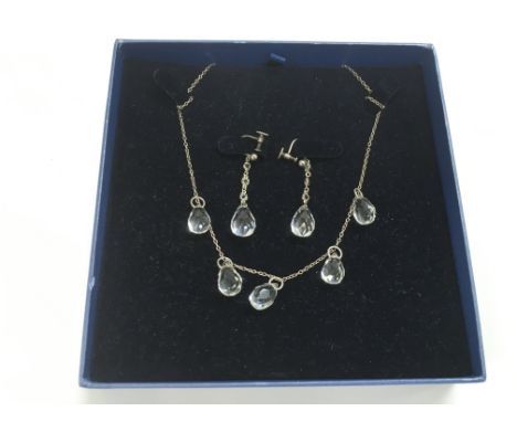 A vintage silver and crystal necklace and matching screw on earrings.