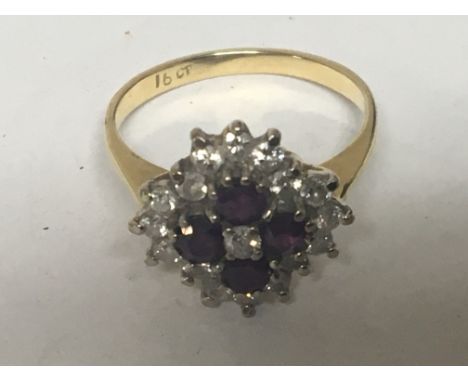 An 18carat gold ring set with a pattern of four ruby and diamonds ring size N.