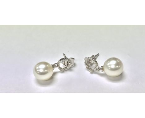 A pair of 9ct white gold Pearl earrings with diamond set hoop bales, the diamonds are 0.05ct.