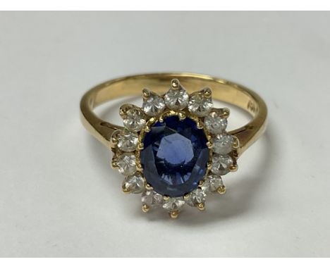 An 18ct gold sapphire and diamond ring. The approximate ring size is between r and s.