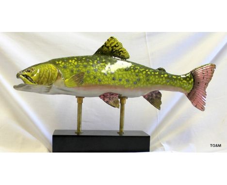 A ceramic figure of a rainbow trout on stand