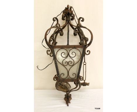 A wrought iron hanging lamp.