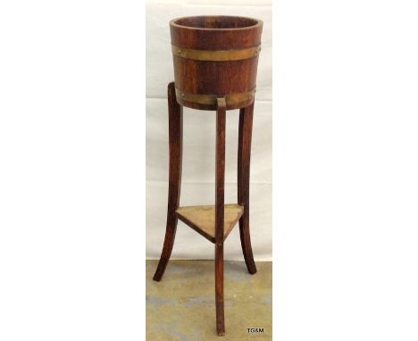 An Oak brass bound planter 91cm tall