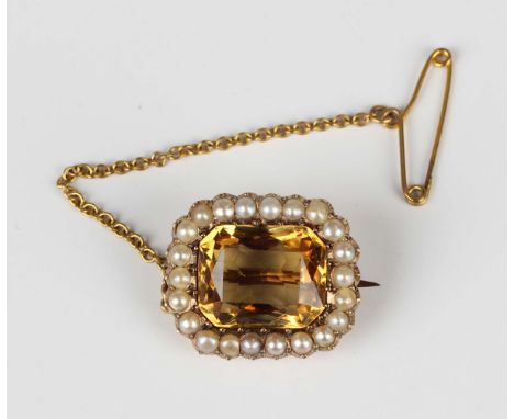 A Victorian gold, citrine and half-pearl set brooch, the cushion cut citrine mounted within a surround of half-pearls, fitted