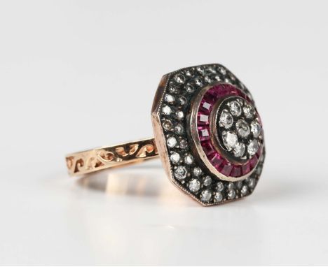 A gold and silver set, treated ruby and diamond hexagonal ring, mounted with eight principal transitional cut diamonds within