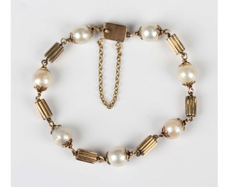 A gold and cultured pearl bracelet in a ridged baton form link design alternating with cultured pearls, on a rectangular snap