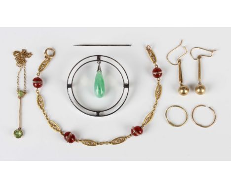 A jade brooch of circular openwork form suspending a central drop shaped jade, diameter 4cm (the pin present but detached), a