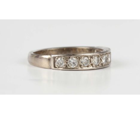 A white gold and diamond half eternity ring, mounted with a row of nine circular cut diamonds, indistinct mark, weight 3.8g, 