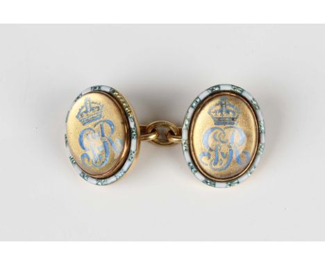 A gold, enamel and reverse intaglio crystal cufflink, the back and front with a pale blue enamelled cypher of King George V w