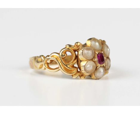 A Victorian gold, ruby and half-pearl cluster ring, mounted with a cushion cut ruby within a surround of six half-pearls betw