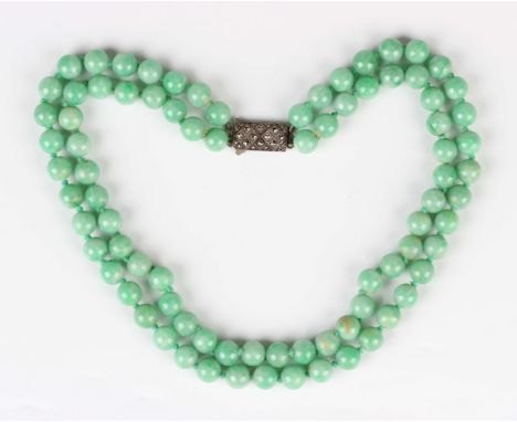 A two row necklace of jade beads on a silver and marcasite clasp, length of shortest strand 41cm.Buyer’s Premium 29.4% (inclu