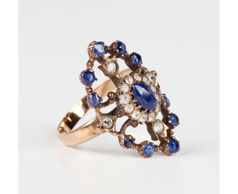 A gold, sapphire and colourless gem set oval panel shaped ring of pierced design, the centre with an oval cluster, unmarked, 