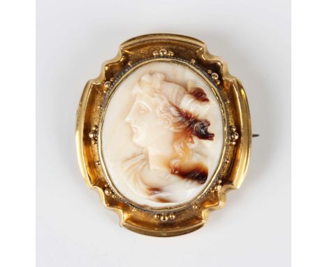 A Victorian gold mounted shell cameo shaped oval brooch, carved as a portrait of a lady within a beaded surround, the back gl