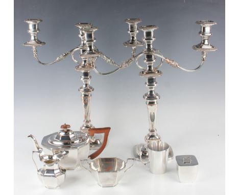 A group of plated items, including a pair of twin scroll branch three-light candelabra with detachable nozzles and gadrooned 