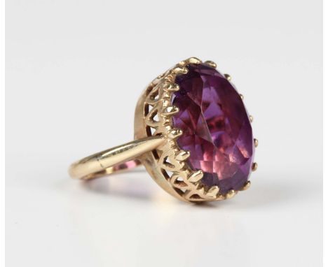 A gold ring, claw set with an oval cut amethyst, detailed '9ct', weight 6.9g, ring size approx I1/2.Buyer’s Premium 29.4% (in