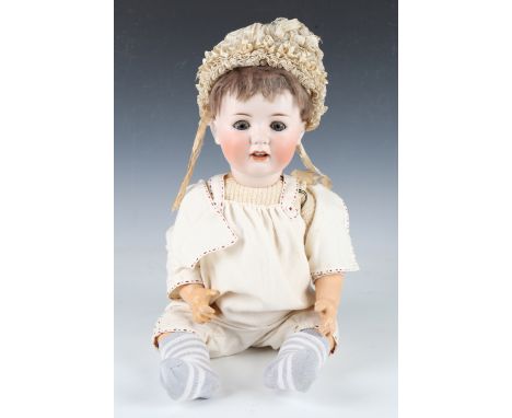 A W. Goebel bisque head doll, impressed 'GW' below a crown, with later brown wig, sleeping eyes, open mouth showing two upper