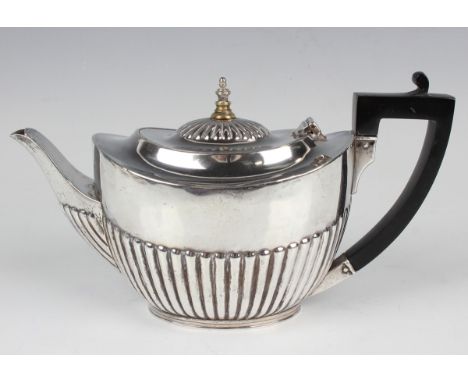 An Edwardian silver oval half-reeded bachelor's teapot, London 1907 by William Hutton &amp; Sons Ltd, weight excluding finial