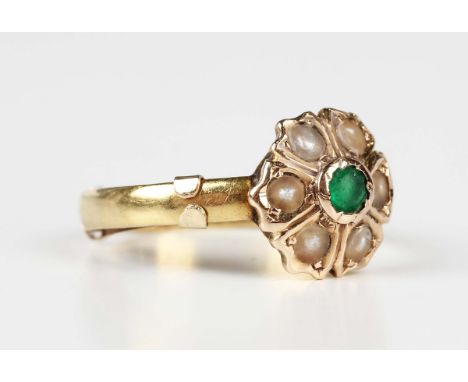 A gold, half-pearl and green gem set cluster ring with engraved motto to shank interior, unmarked, fitted with a sizing band,