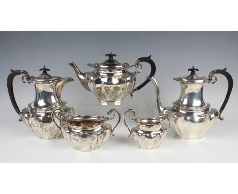 A George V silver five-piece tea and coffee set of oval lobed form, comprising teapot, coffee pot, hot water pot, two-handled