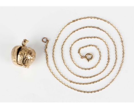 A 9ct gold pendant, designed as an apple, opening to reveal Adam and Eve, London 1961, weight 9.5g, length 2.4cm, with a gold
