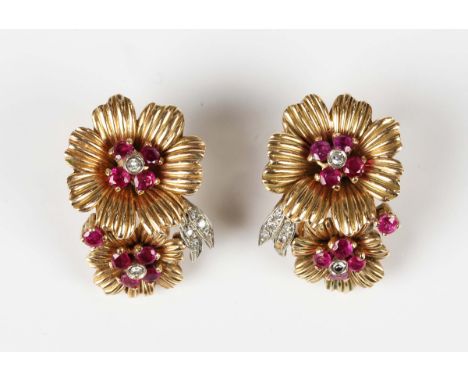 A pair of gold, ruby and diamond earclips, each designed as two flowerheads mounted with circular cut rubies and diamonds, un