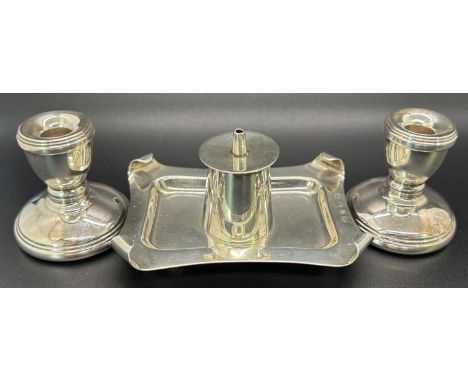 A group of silver containing a pair of squat candle sticks and a seal pour on drip tray, mixed makers, Birmingham 